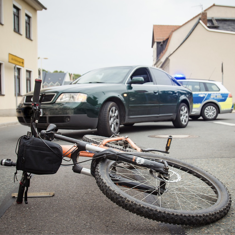 a bike on the ground with police cars