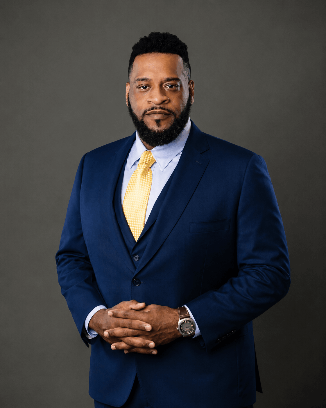 Attorney Aaron Winder in a suit wth yellow tie